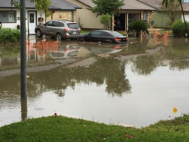 Flash flooding in a neighborhood where storm drains were blocked by construction debris. (Image: Adolfo Romero)
