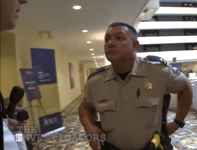 Chatham County Sheriff's Deputy O'Berry ejects a WXIA-TV news crew from a Savannah, Ga. hotel room at the direction of a senior official of the American Legislative Exchange Council.