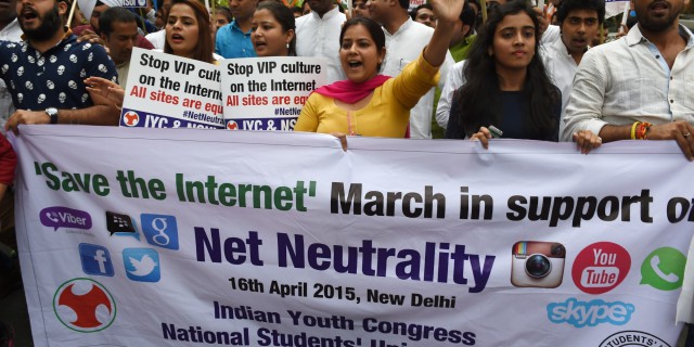 Activists of Indian Youth Congress and National Students Union of India shout anti-government slogans during a protest in support of net neutrality in New Delhi on April 16, 2015. India's largest e-commerce portal Flipkart on April 14 scrapped plans to offer free access to its app after getting caught up in a growing row over net neutrality, with the criticism of Flipkart feeding into a broader debate on whether Internet service providers should be allowed to favour one online service over another for commercial or other reasons -- a concept known as "net neutrality". AFP PHOTO / MONEY SHARMA (Photo credit should read MONEY SHARMA/AFP/Getty Images)